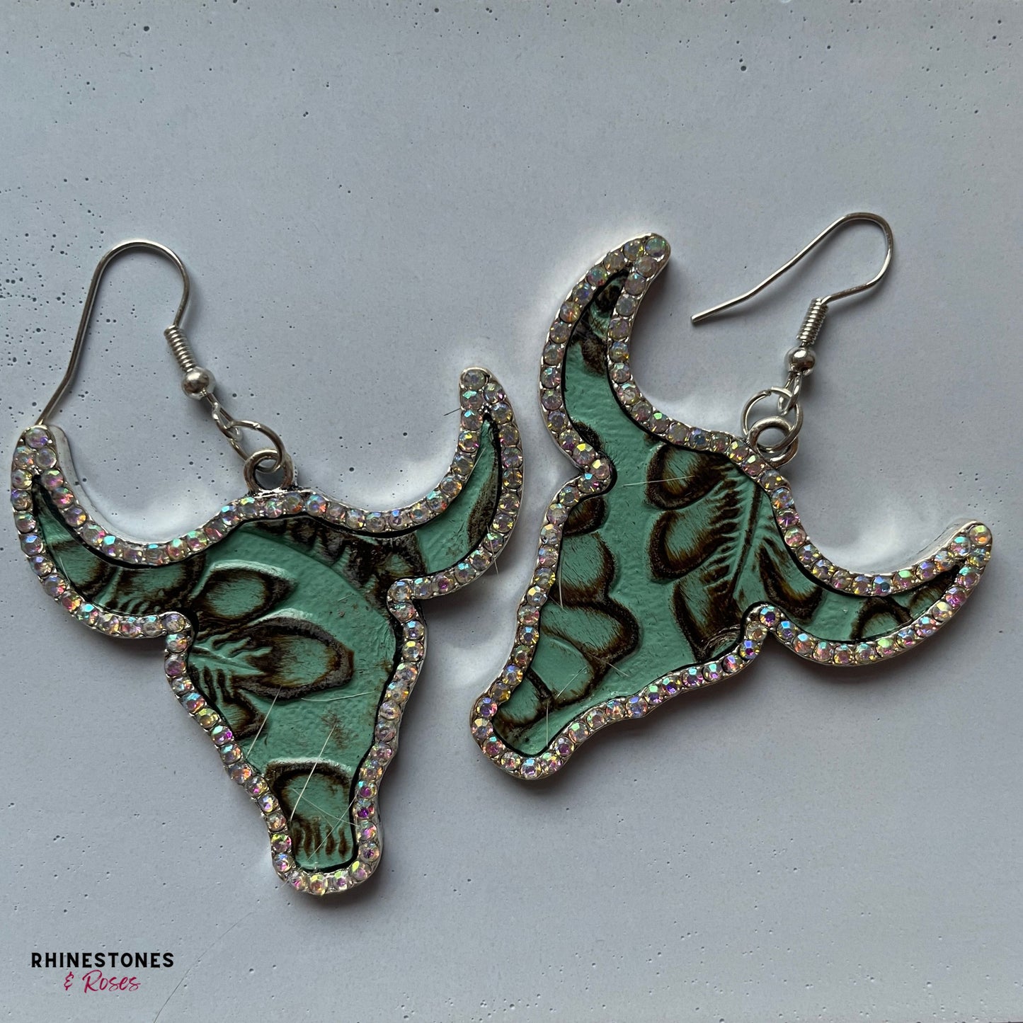 Leather look embossed earrings in the shape of a longhorn bull 