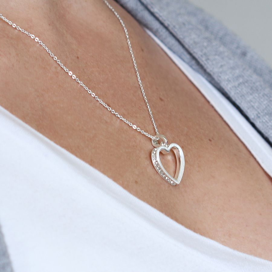 Inset crystal heart necklace being worn