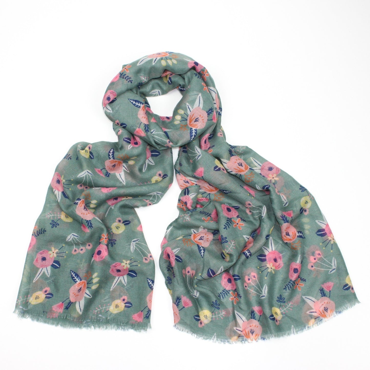 Delicate pastel pink flower printed scarf on a green background with feathered edge