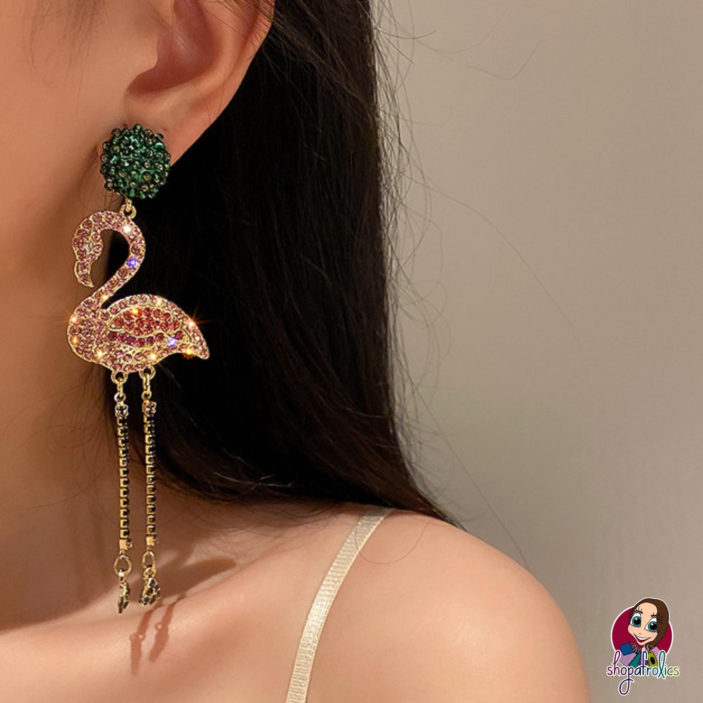 pink crystal flamingo earrings modelled in ear