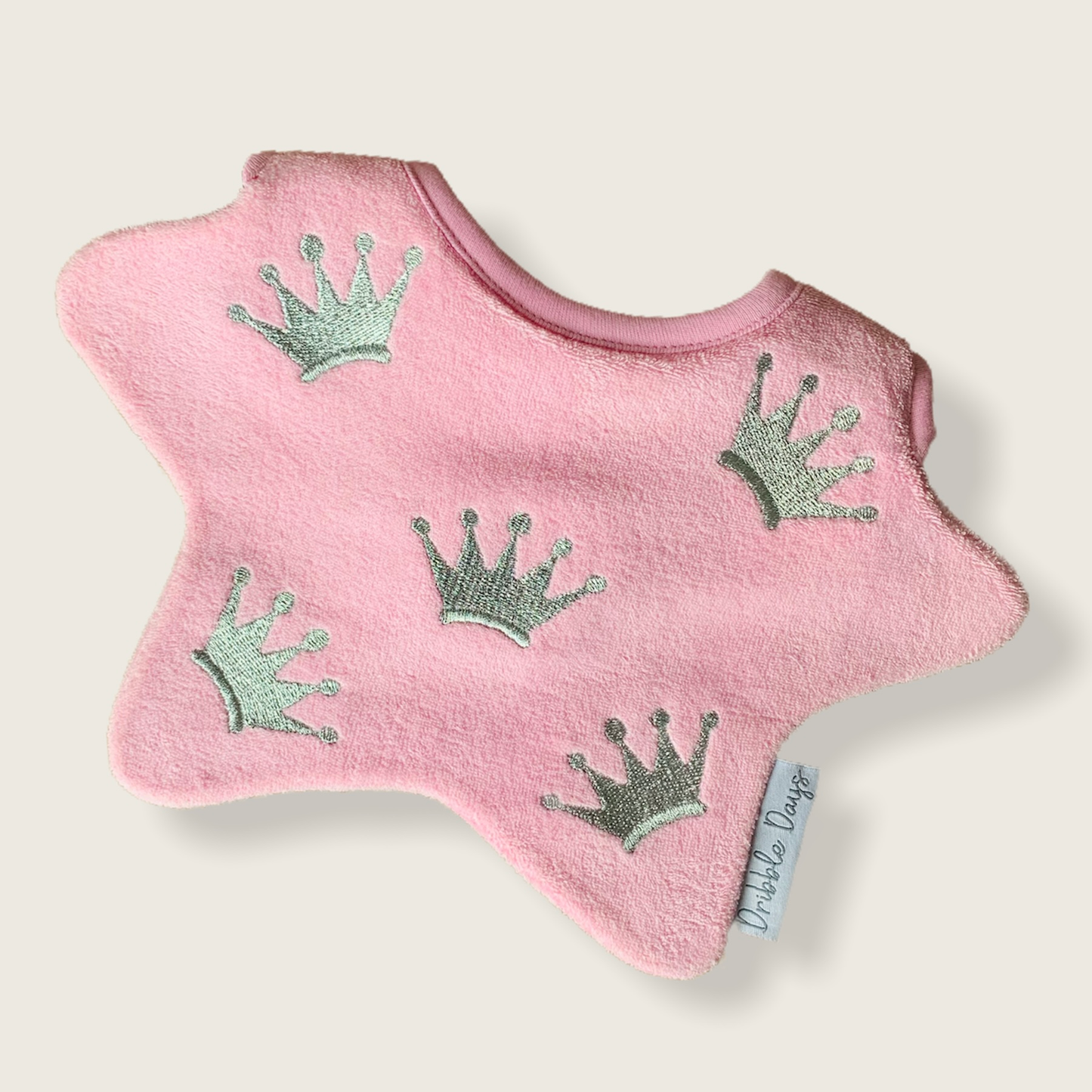 Pink bib with embroidered princess crowns
