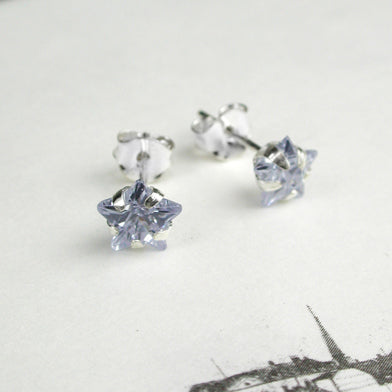 Sterling silver stud earrings with faceted crystal stars. Choice of black, clear or purple.