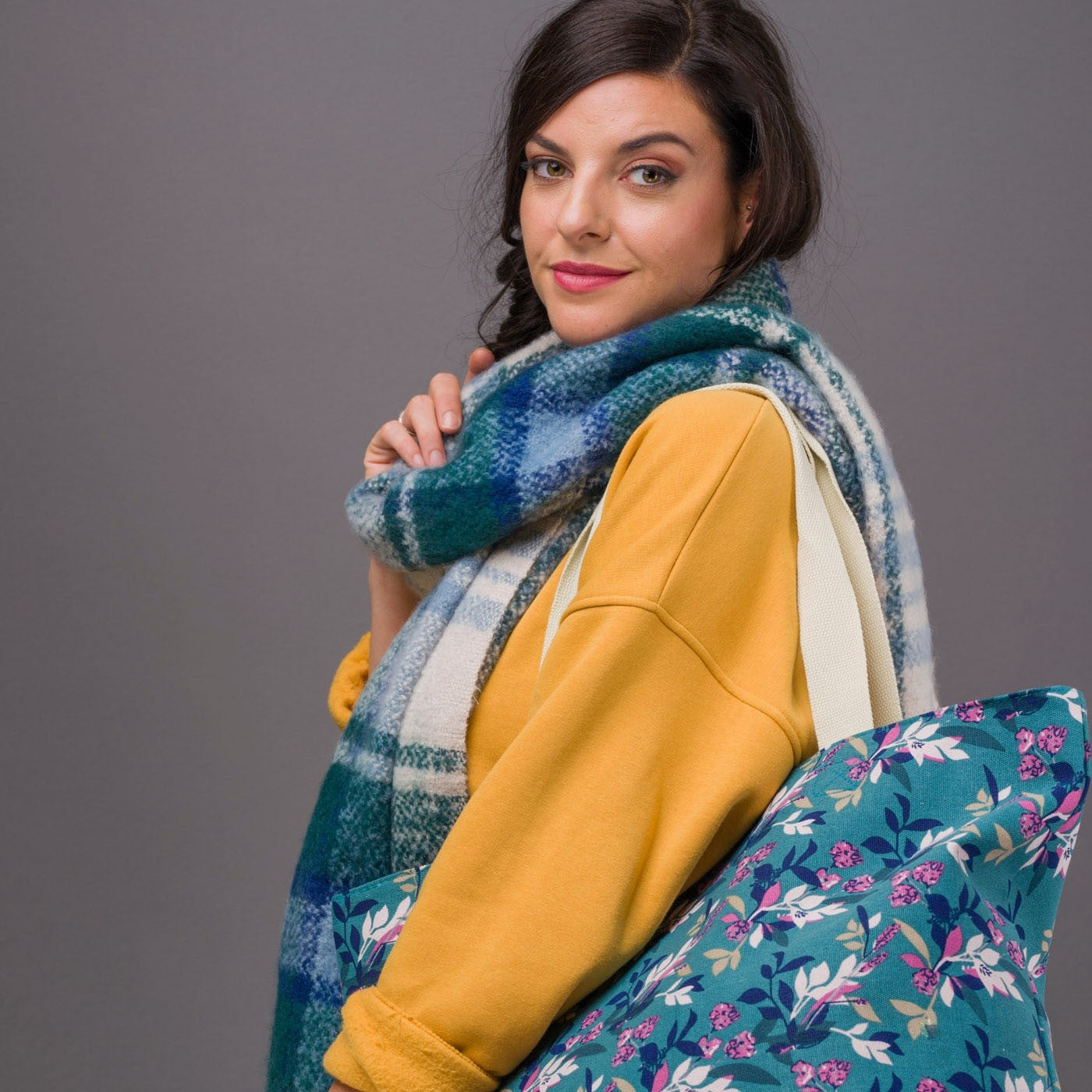 Large canvas bag with vintage style floral print, on a solid green coloured background