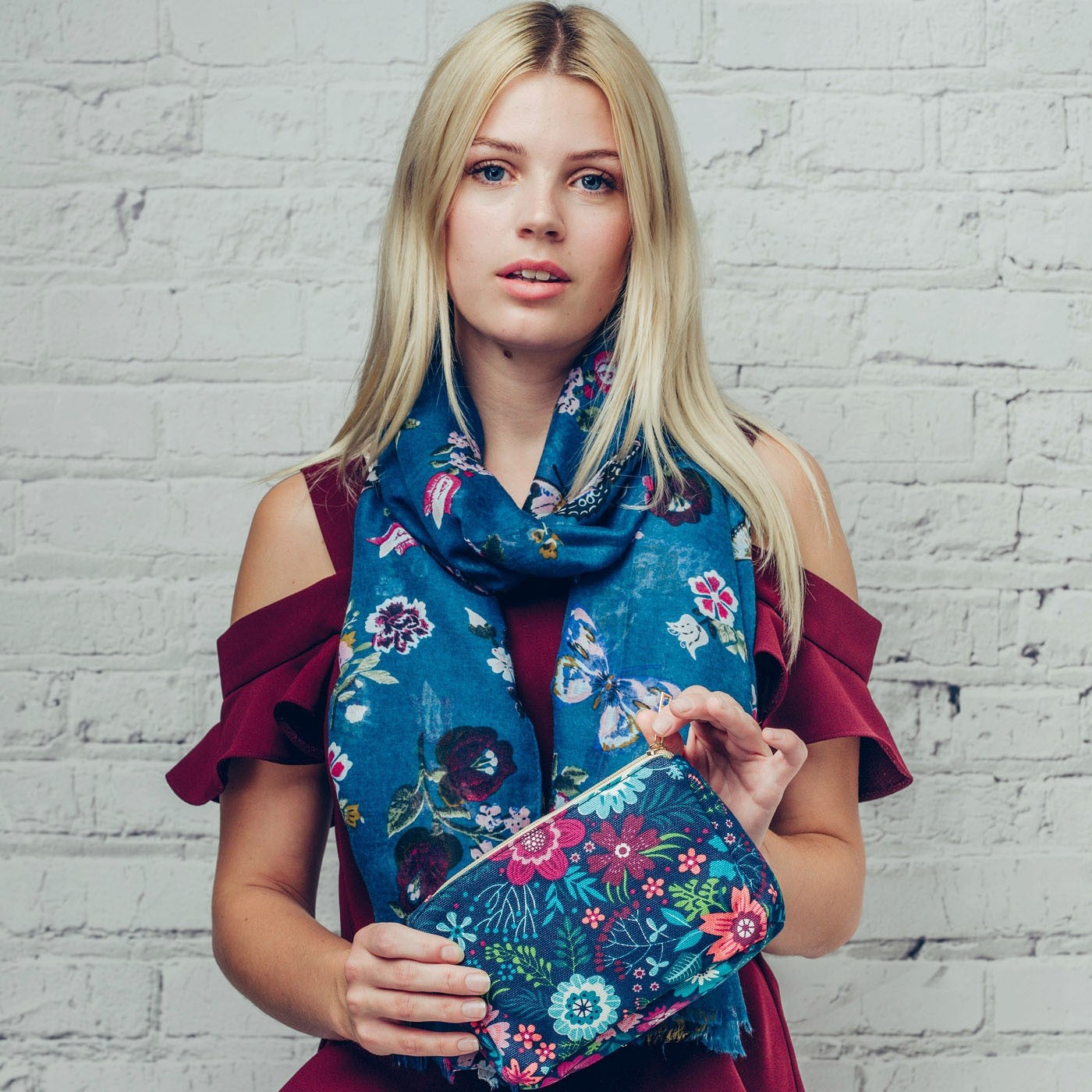 Make up bag in bold blue and pink floral design on a dark background