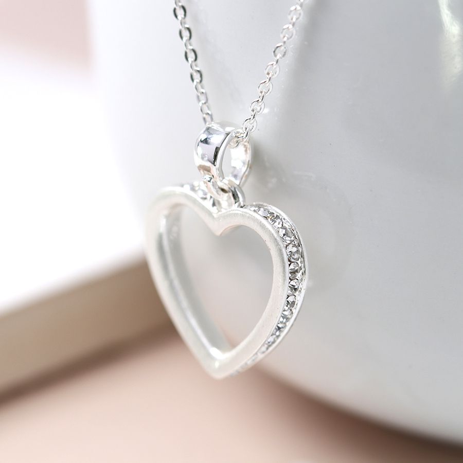 Silver plated fine chain necklace with a brushed silver plated open heart edged with tiny crystals