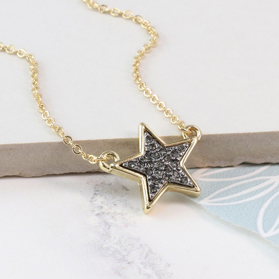 Gold-plated split chain necklace with a golden star pendant featuring a black enamel sparkle centre.