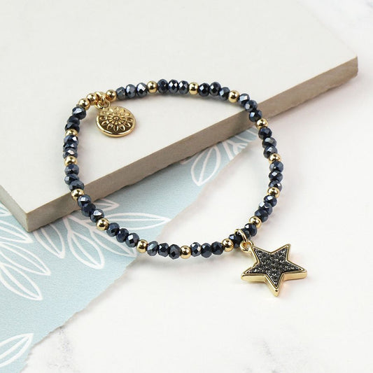 Golden bead and black bead bracelet with a golden star charm with black enamel sparkle centre.