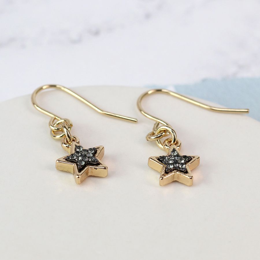 Dainty gold-plated star drop earrings featuring a black enamel sparkle centre, with gold plated earring hook wires.