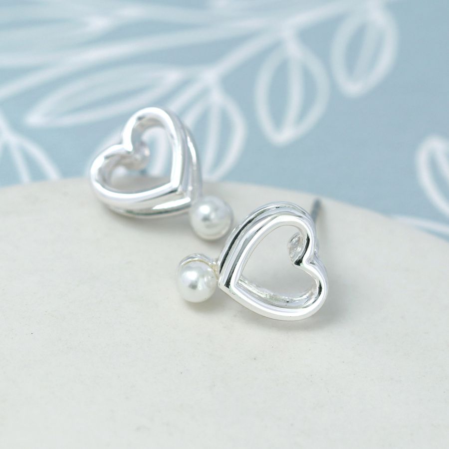 Double layer heart stud earrings with white faux pearls.