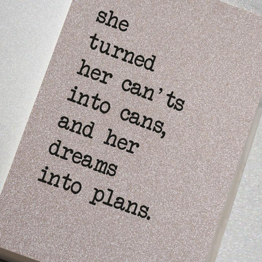 A magical and sparkling glitter covered notebook featuring in the slogan: She turned her can'ts into cans, and her dreams into plans.