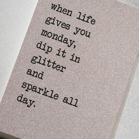 A fabulously sparkling silver glitter effect covered notebook featuring in the slogan: When life gives you Monday, dip it in glitter and sparkle all day.