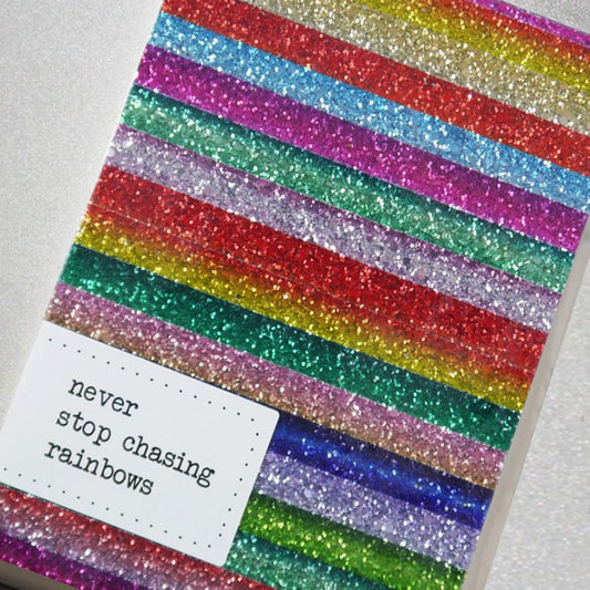 This perfectly sparkly notebook is handmade from glitter fabric featuring a beautiful multicolour rainbow stripe design. 