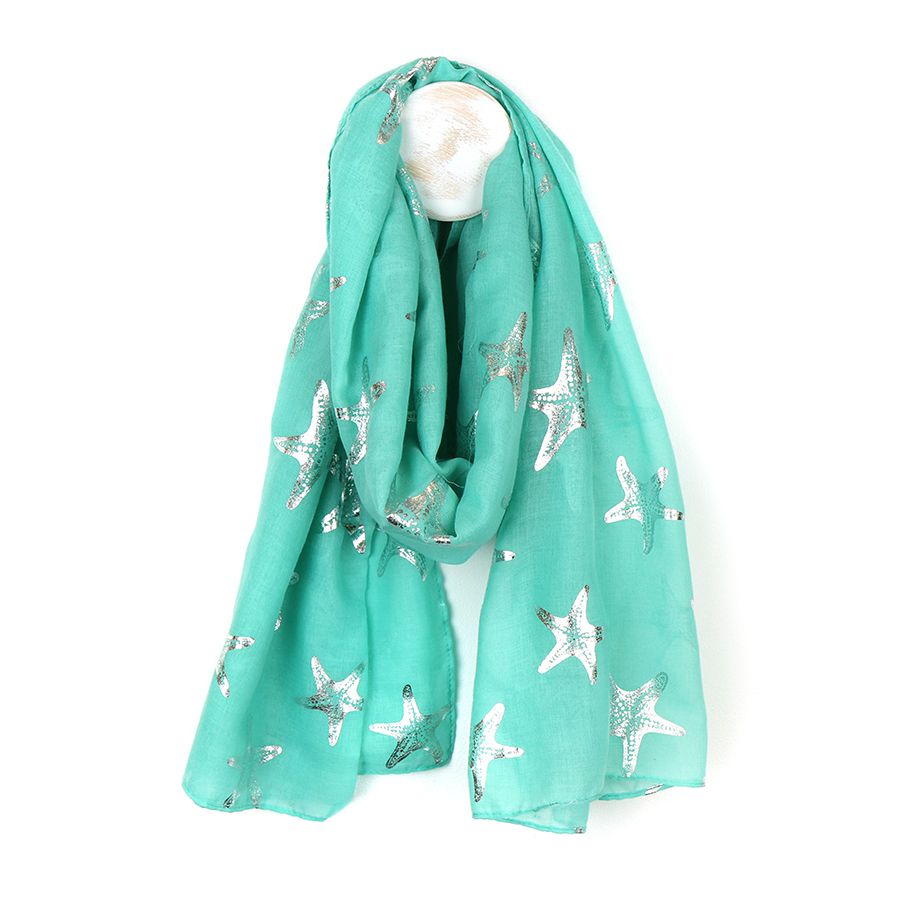 Dream of the seaside with this aqua green scarf with metallic silver foil starfish print