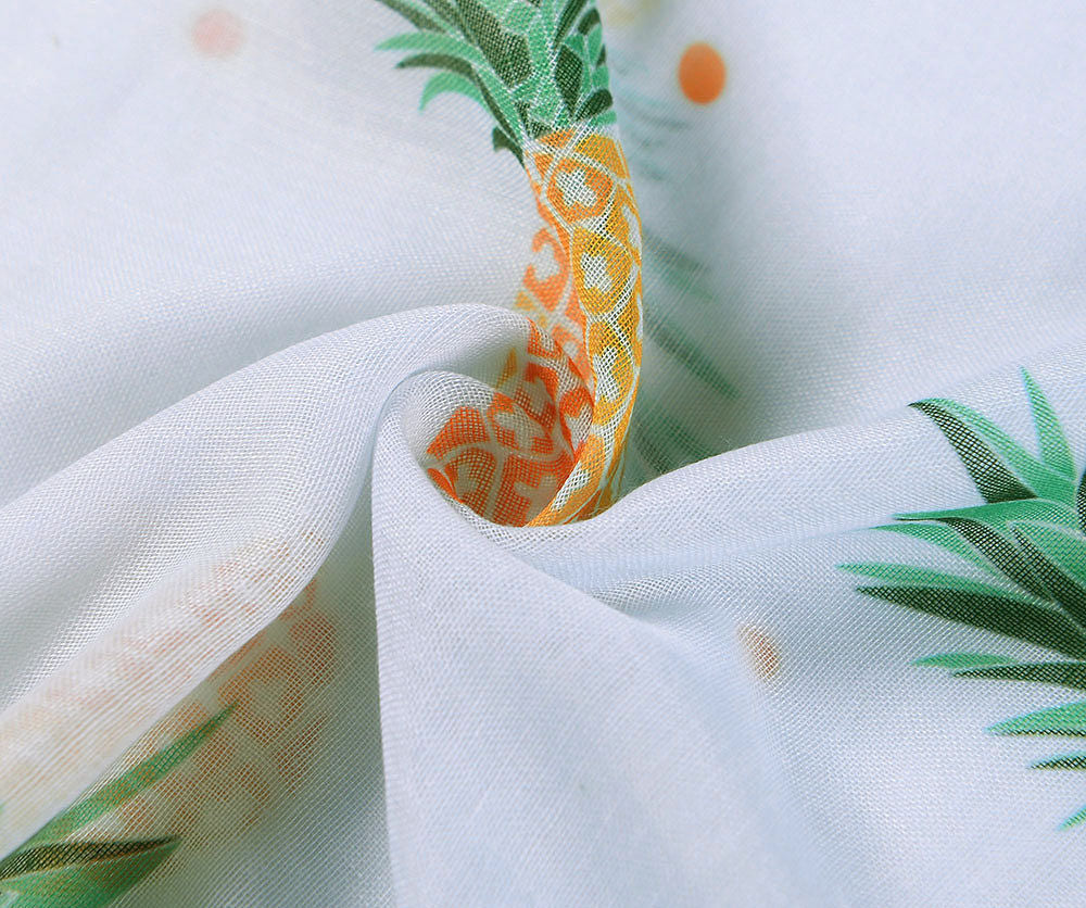 Close up of Lovely pineapple printed scarf on a soft white fabric.