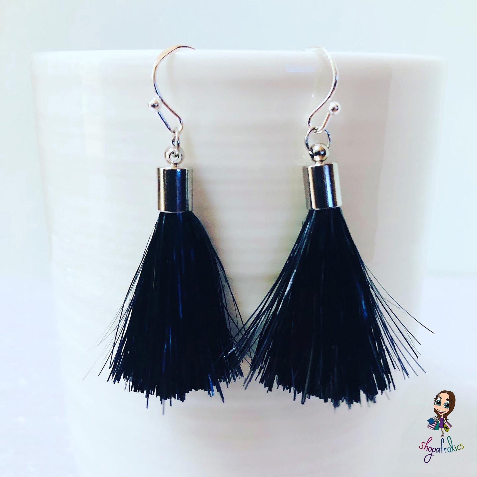 Close up of black and silver tassel earrings
