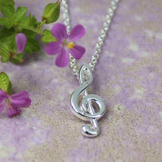 Dainty treble clef necklace plated in pure silver.