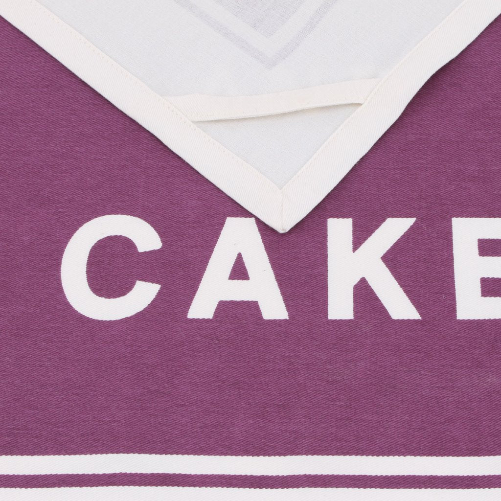 Vibrant purple tea towel featuring the slogan: Everything Stops For Tea and Cake 