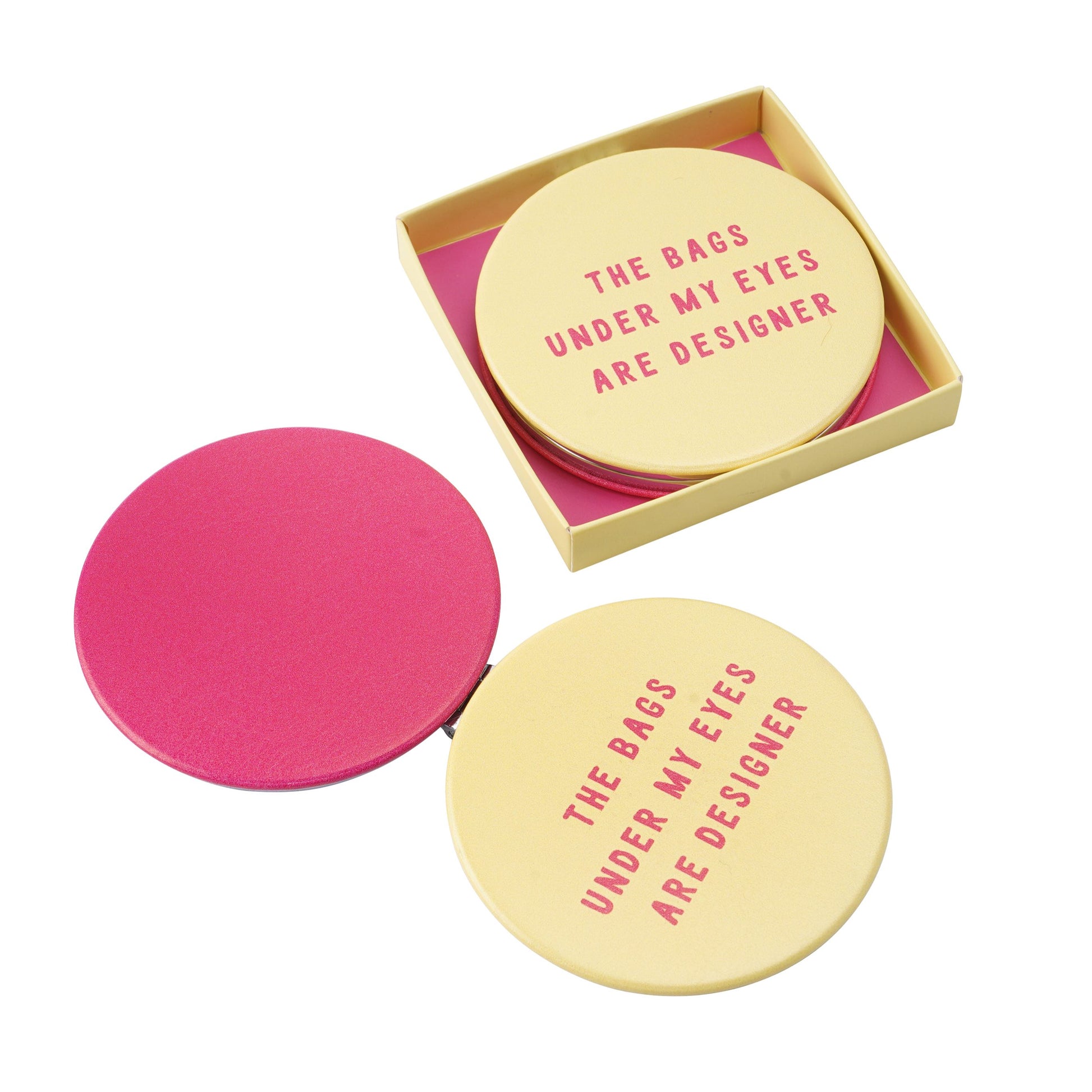 Yellow and pink compact mirror, with the fun slogan The bags under my eyes are designer.