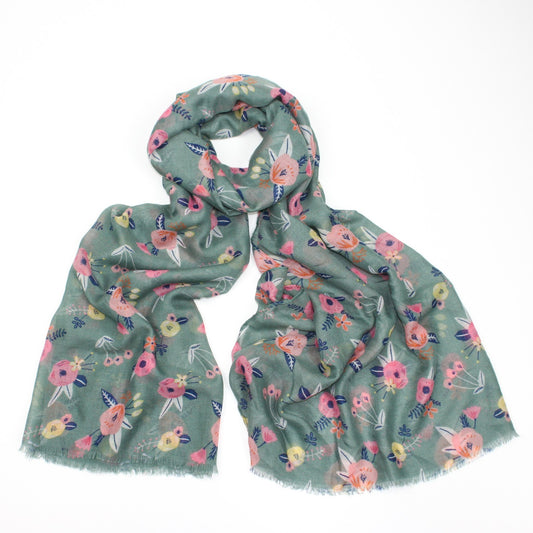 Delicate pastel pink flower printed scarf on a green background with feathered edge 