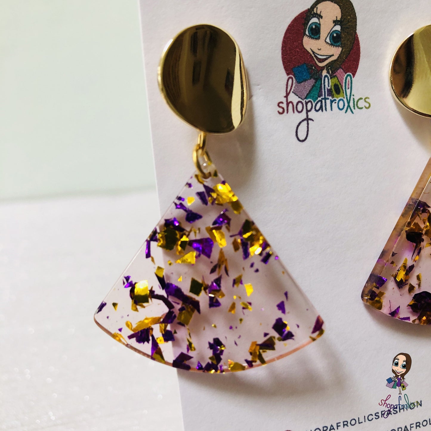 A gold and purple confetti effect, in a clear fan adds the statement to these drop earrings