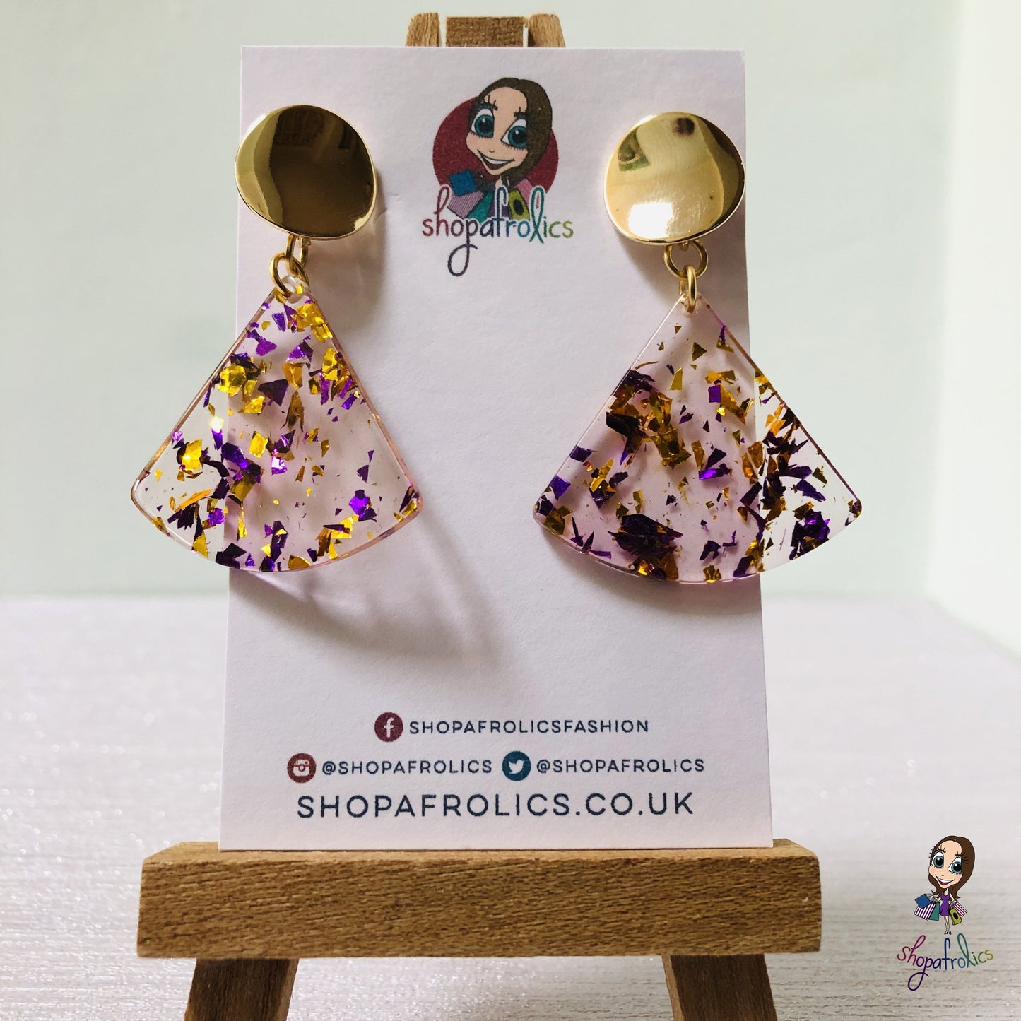 A gold and purple confetti effect, in a clear fan adds the statement to these drop earrings