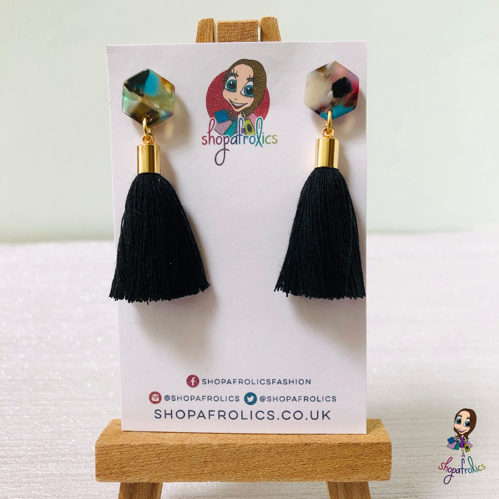 black cotton tassel drop earrings are finished with a vibrant coloured hexagon acrylic ear stud. 