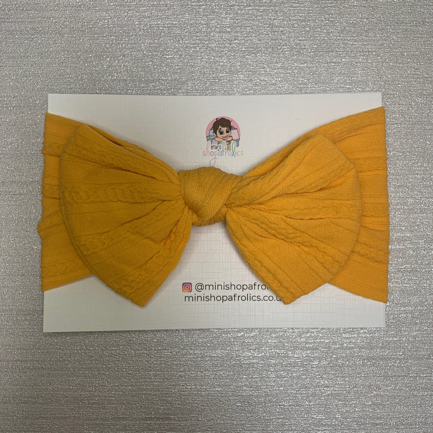 Honey yellow baby bow headband on backing card
