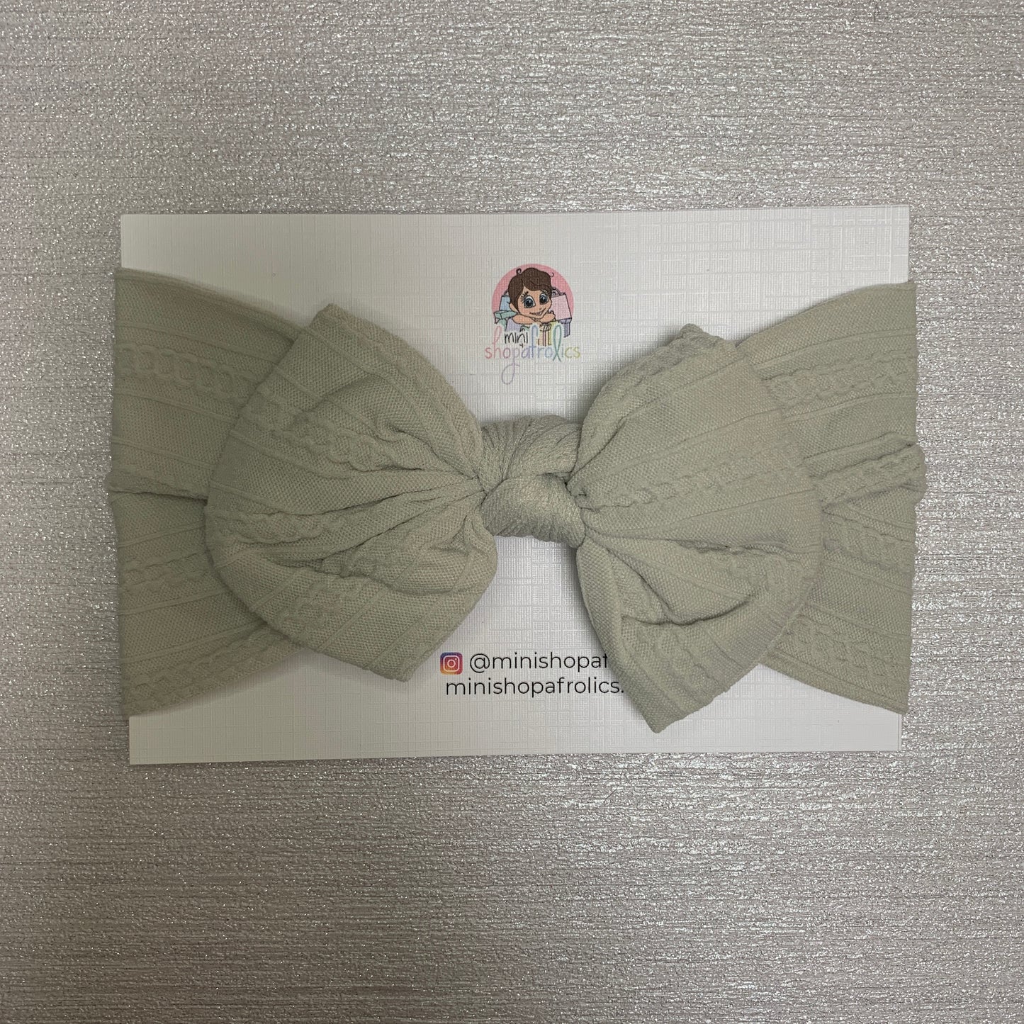 Light grey hairband on backing card