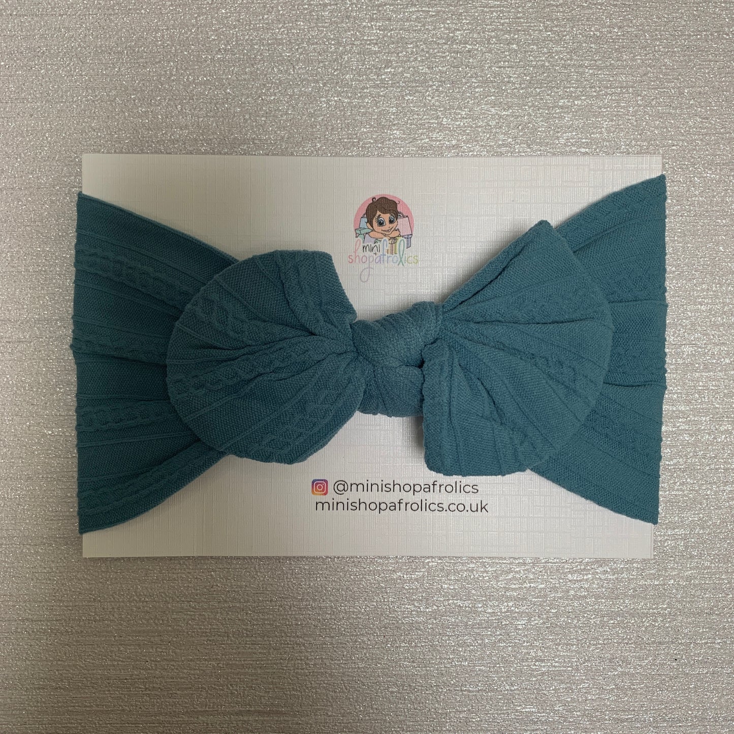 Petrol blue hairband on backing card