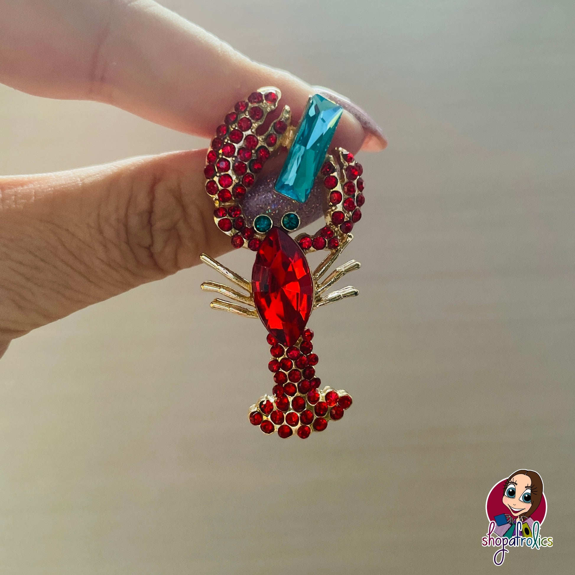 Close up of red lobster earrings 