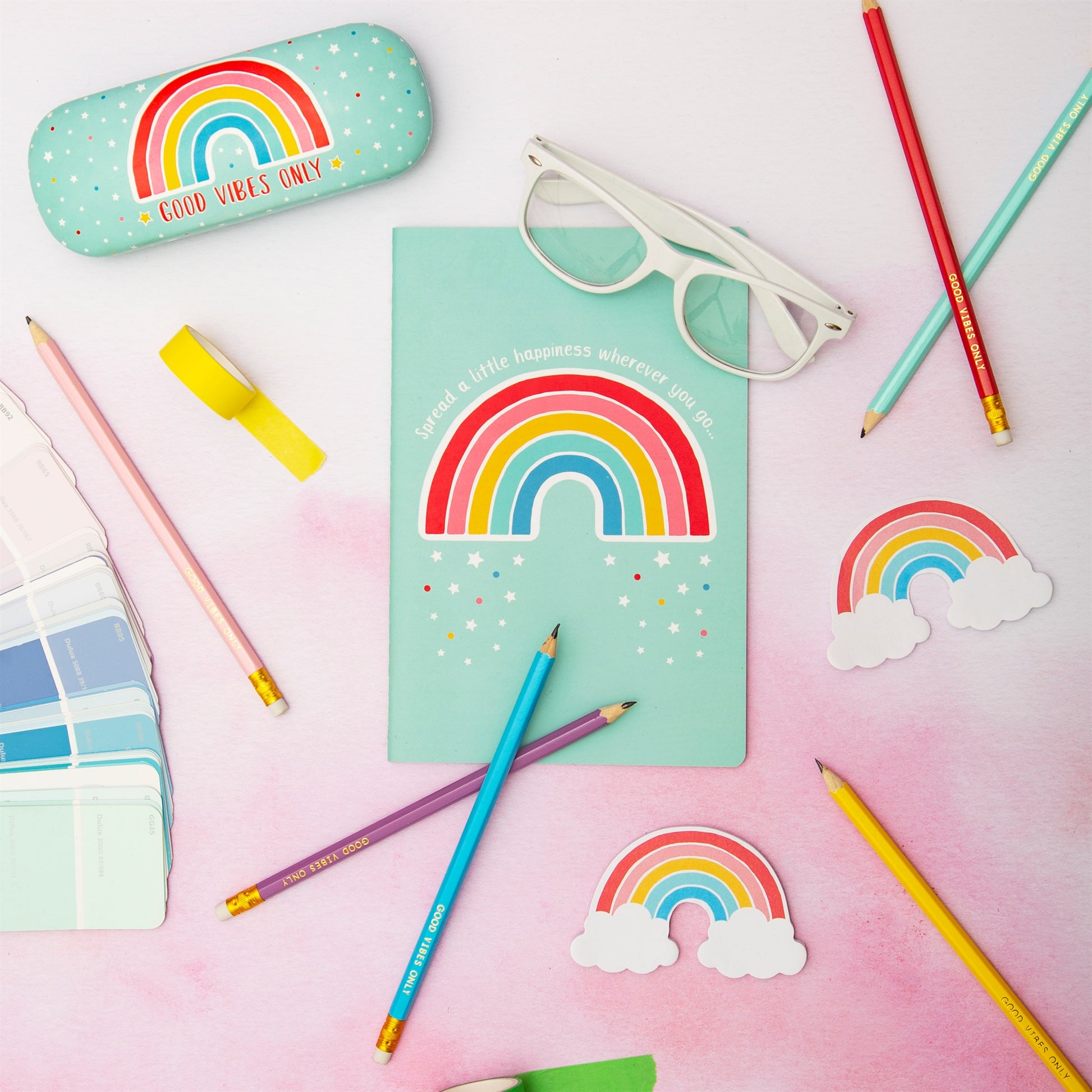 Rainbow notebook with slogan spread a little happiness wherever you go flatly