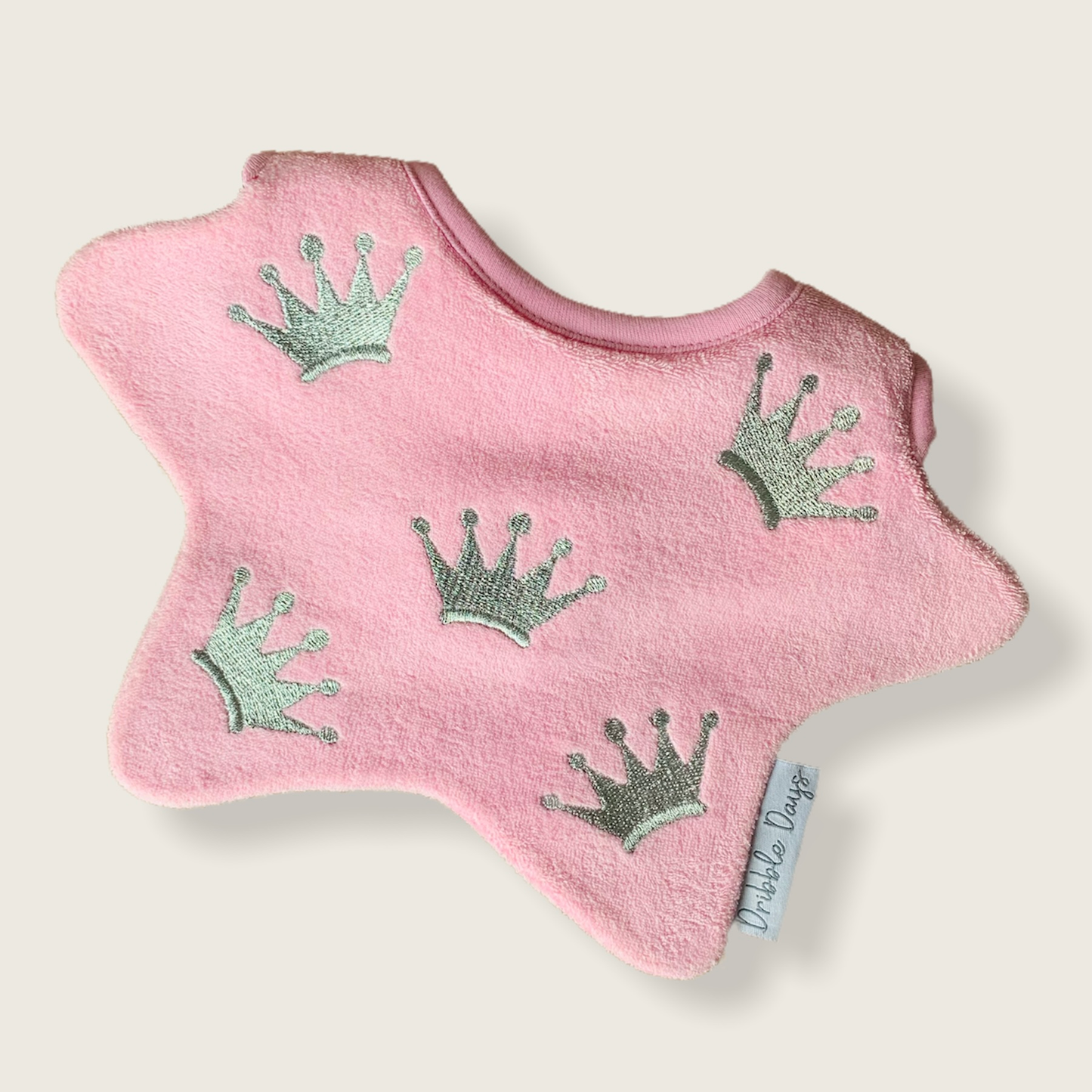 Pink bib with embroidered princess crowns 