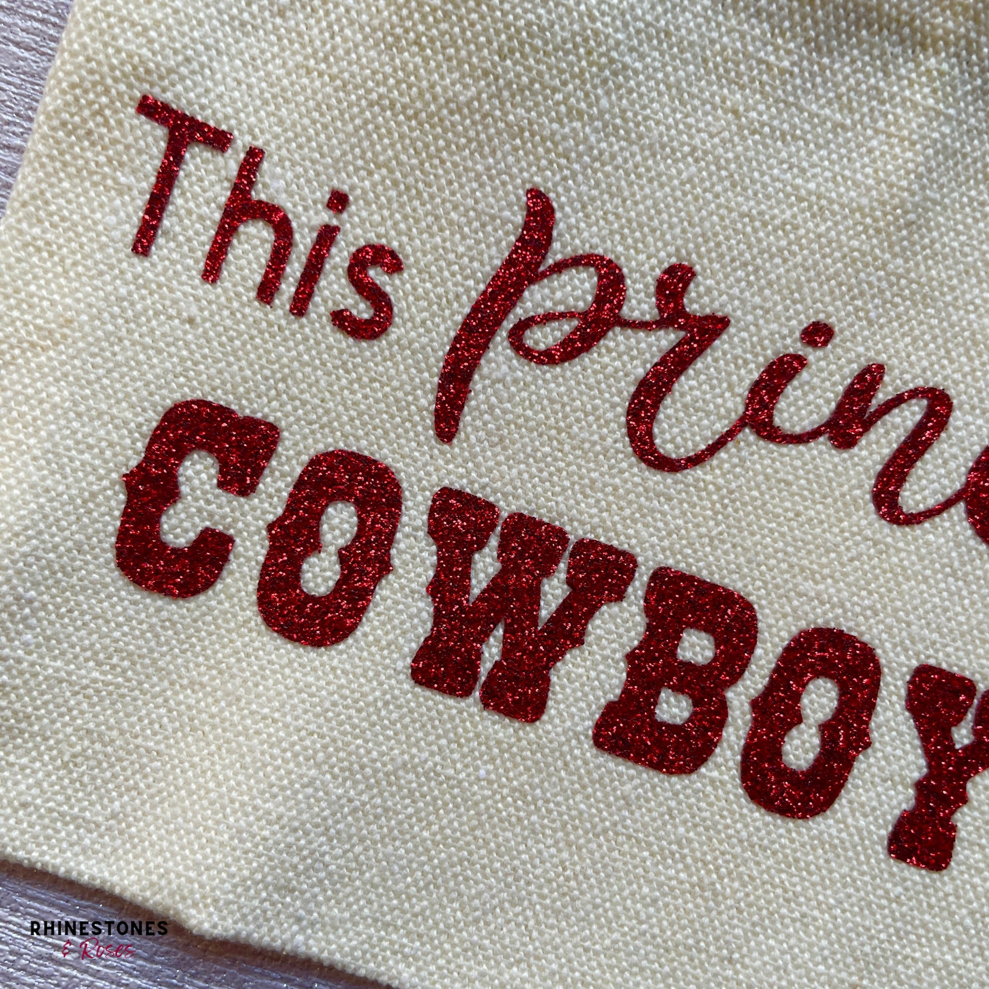 Close up of red glitter letter on This Princess Wears Cowboy Boots make up pouch