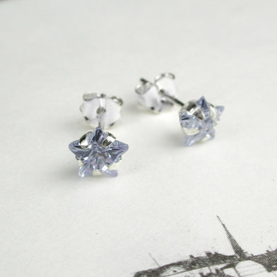 Sterling silver stud earrings with faceted crystal stars.  Choice of black, clear or purple.