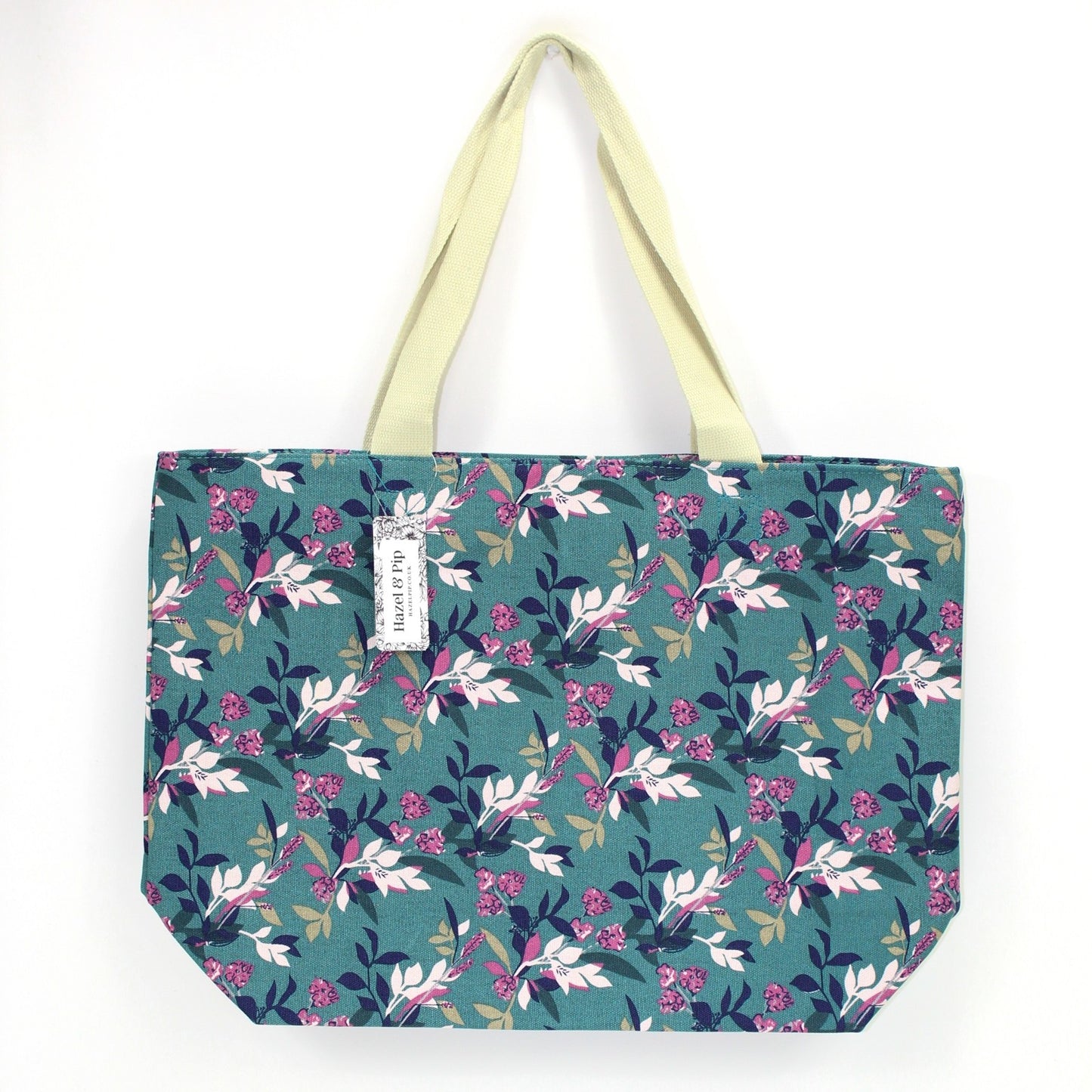 Large canvas bag with vintage style floral print, on a solid green coloured background
