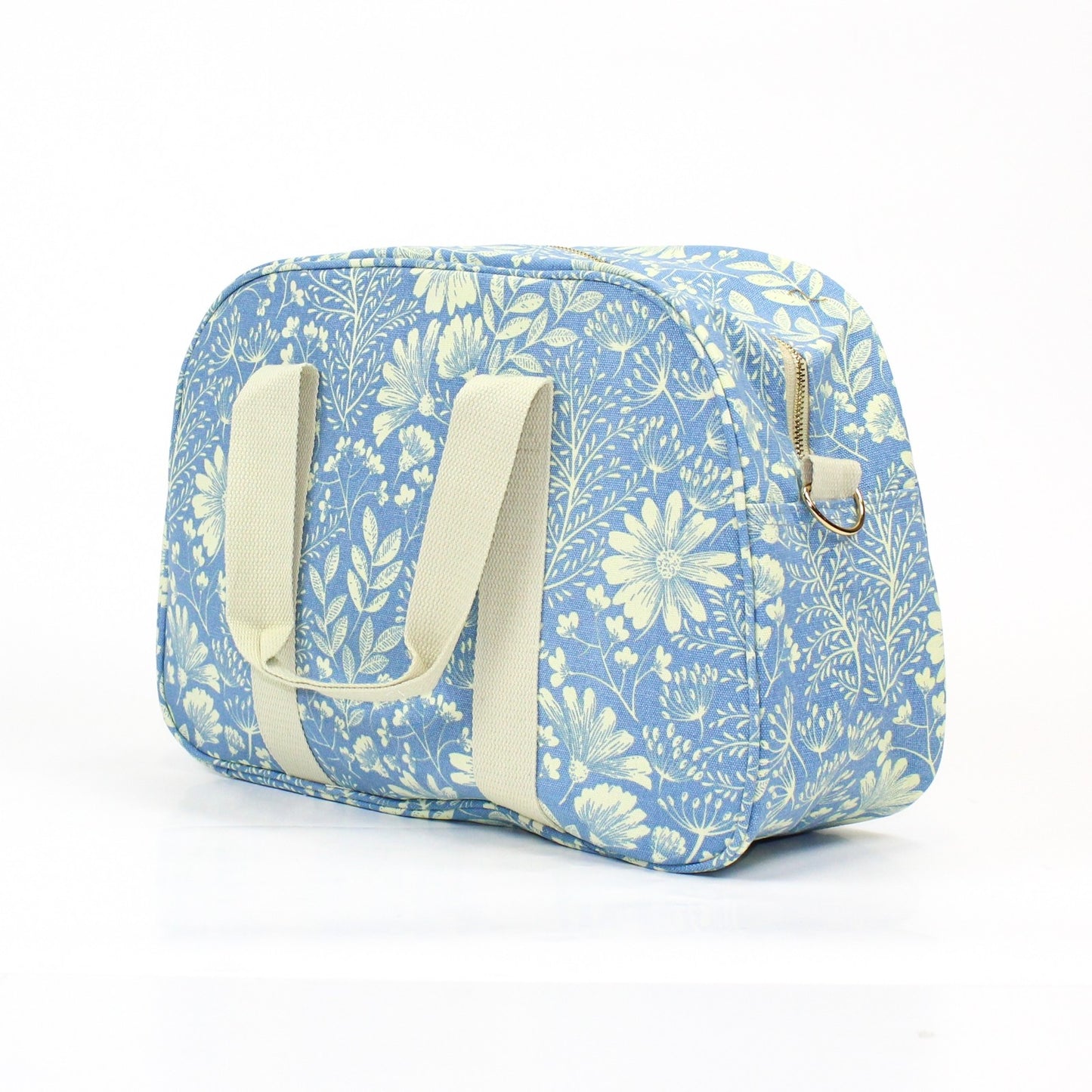 Pretty floral print weekend bag, on a light powder blue background.
