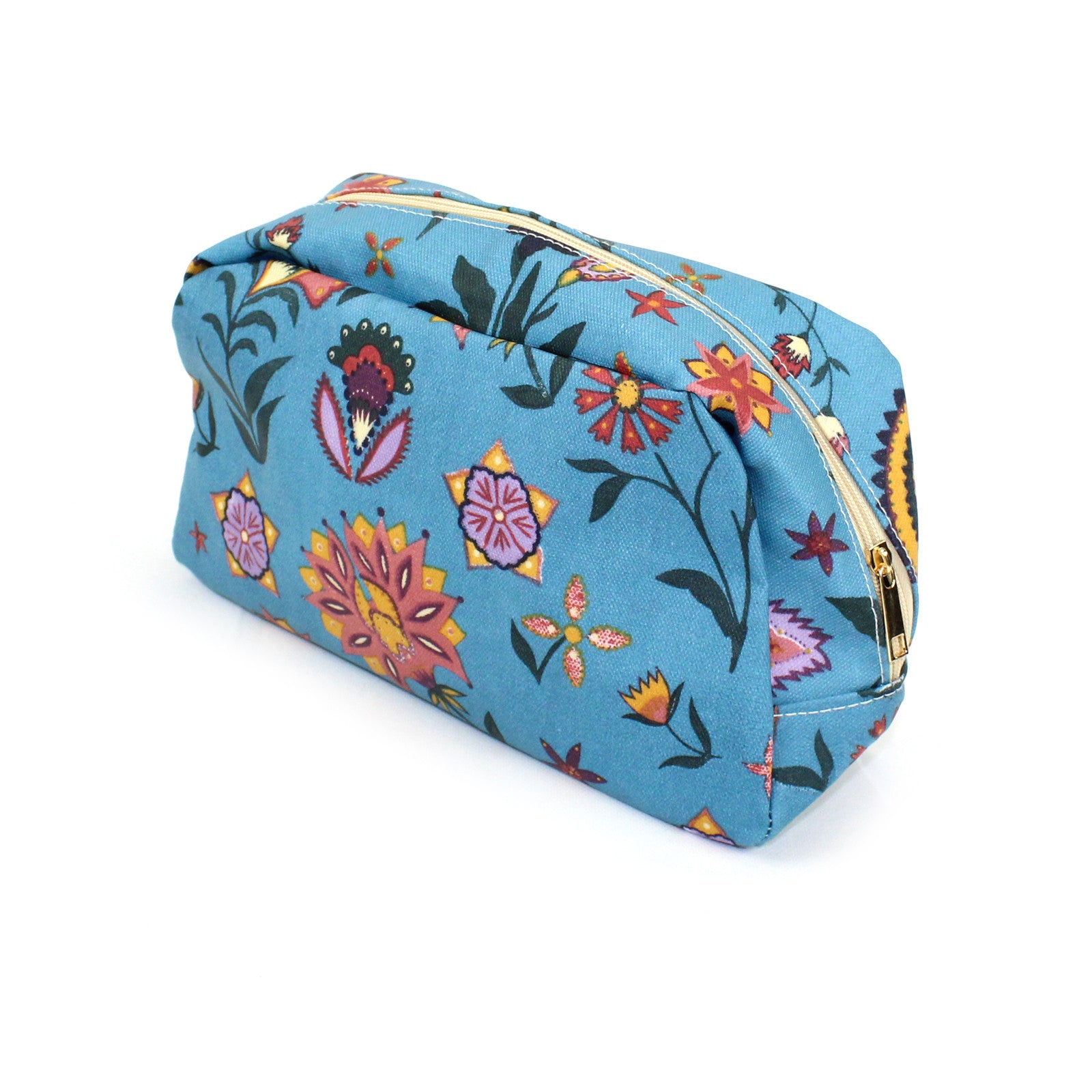 Large oil cloth make up / wash bag with a pretty paisley print with a boho vibe, on a solid blue background.