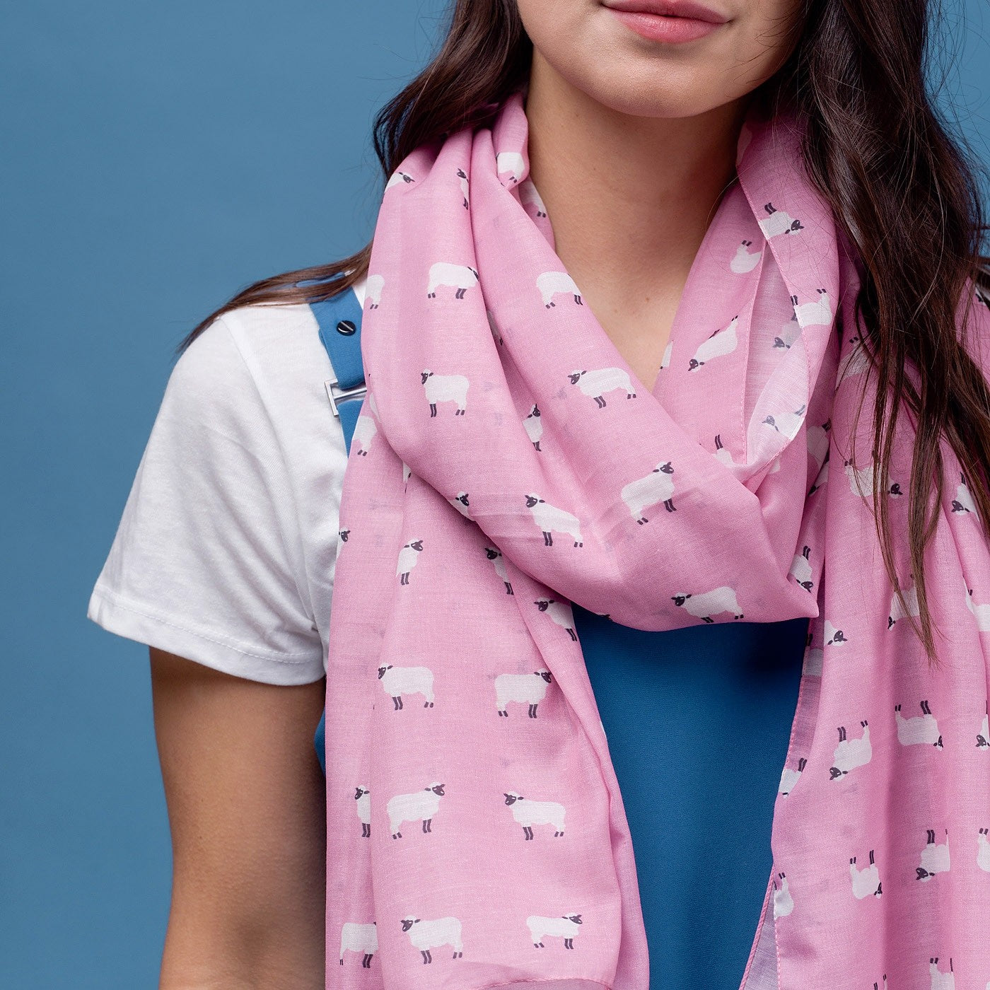 Pink sheep print scarf, finished with a rolled edge.