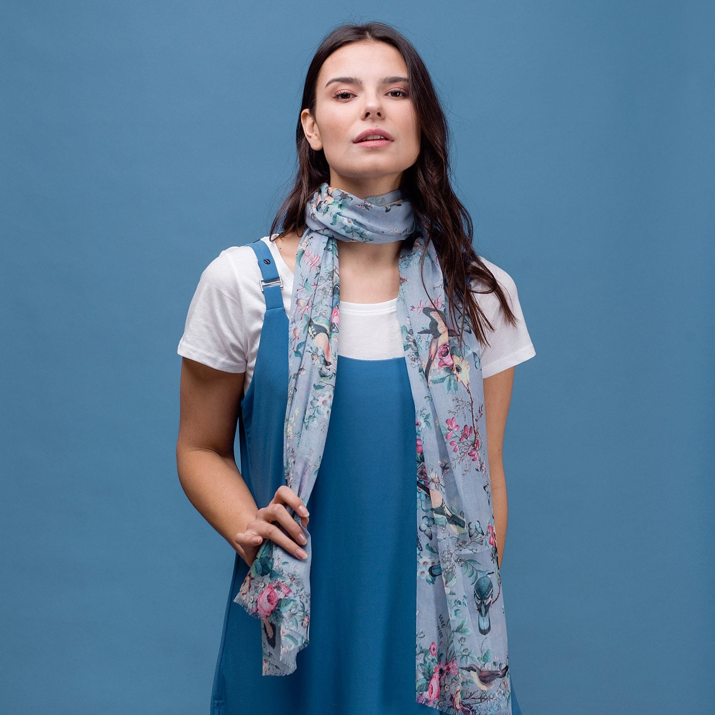 Delicate butterfly and bird print scarf in blue with rolled edge.