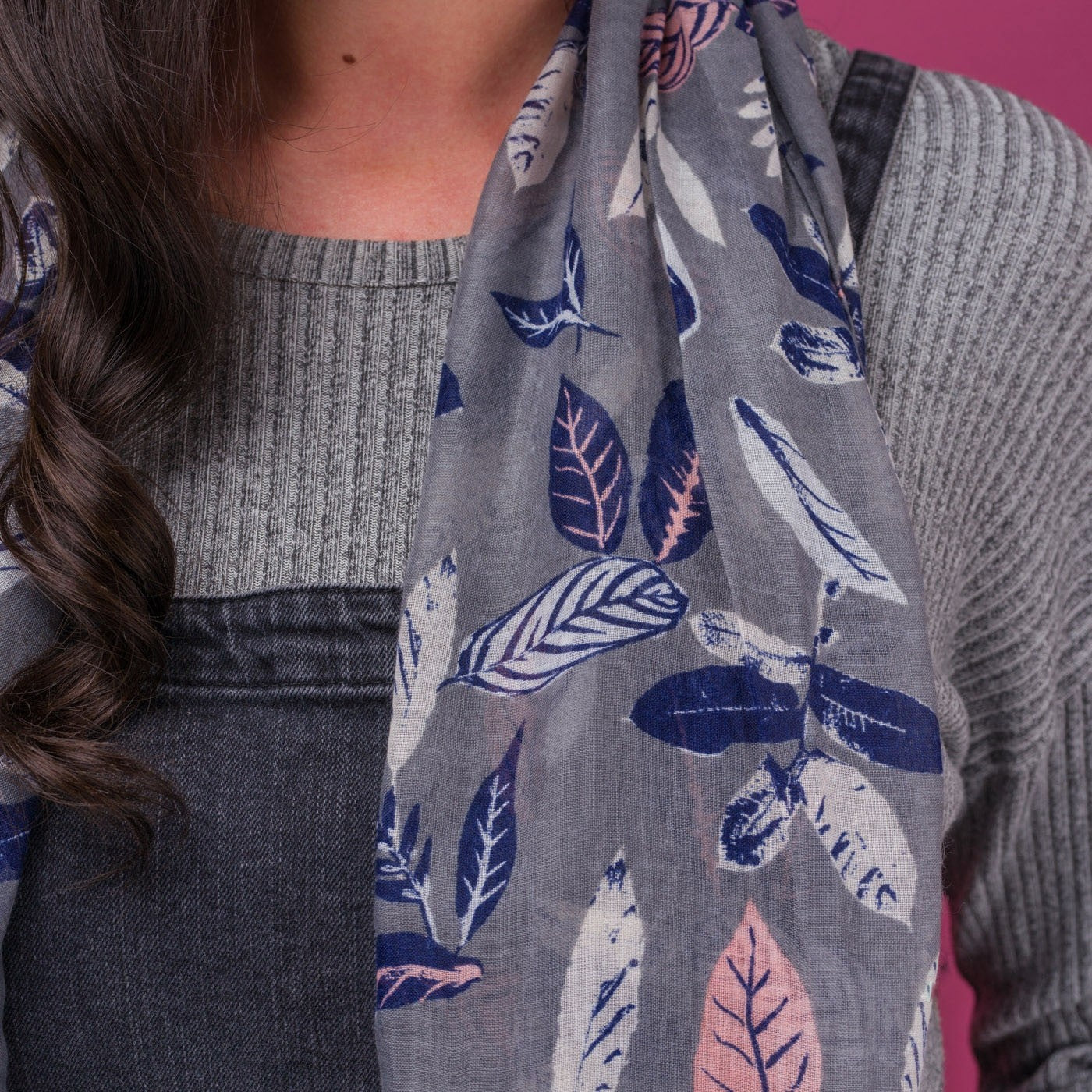 Close up of Pretty vintage leaf print scarf on a solid grey coloured background and finished with a rolled edge