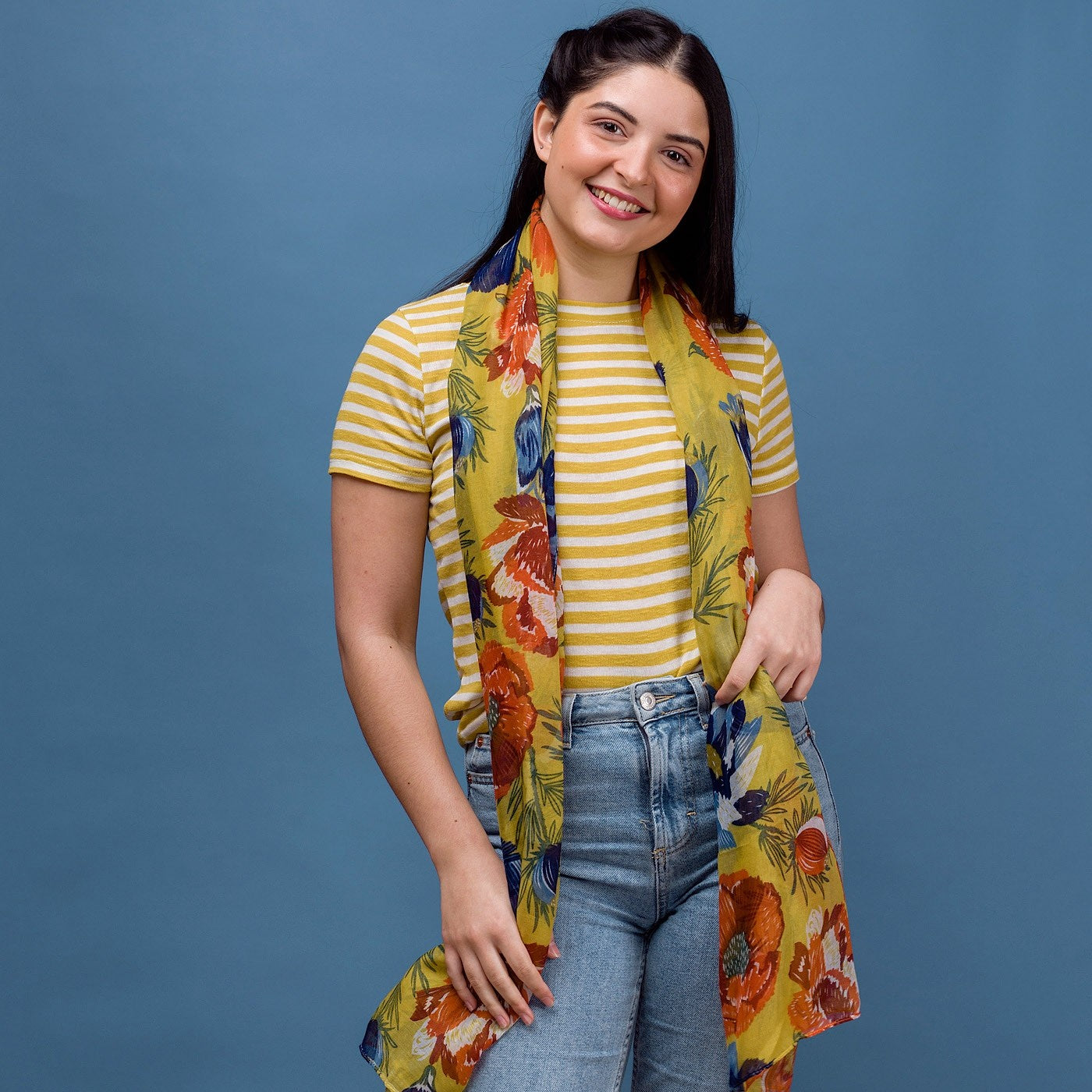 Bold and pretty this anemone floral print scarf is inspired by a summer meadow. Yellow with vibrant red and blue flowers. 